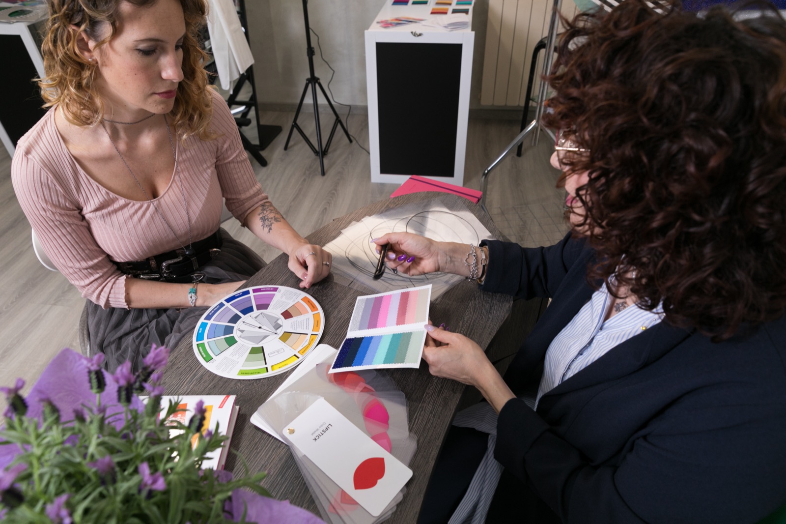 Pierangela mostra i drappi colore a una cliente con la ruota dei colori durante una consulenza di armocromia